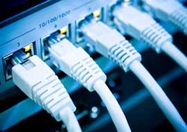 Image of a networking switch with ethernet cables plugged in